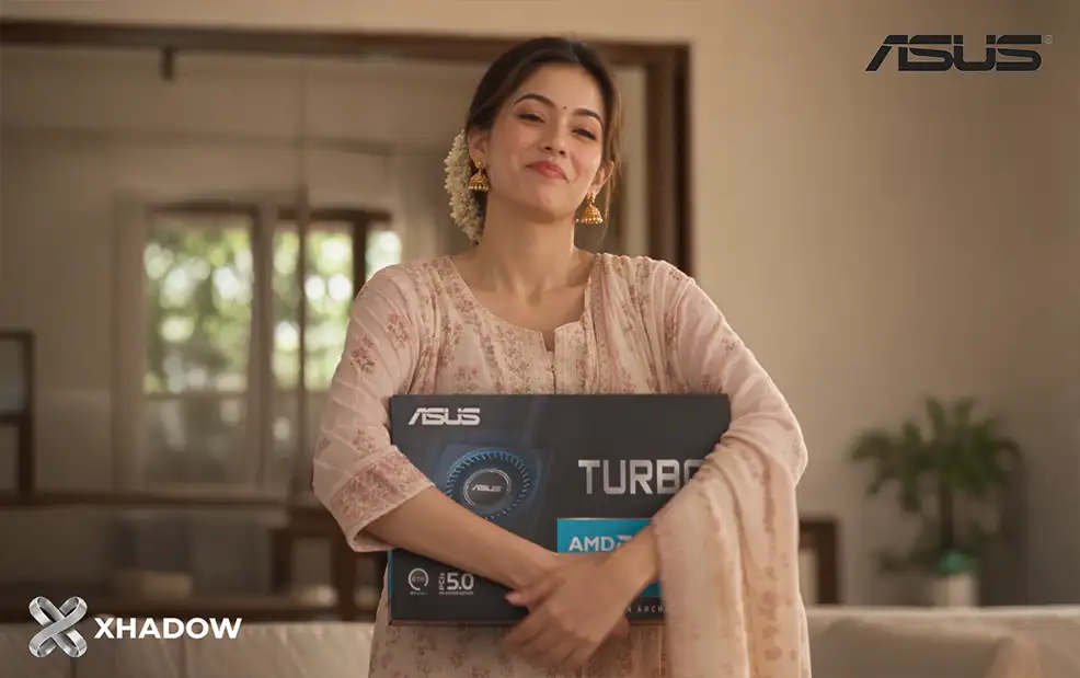Sanvii holding the boxed ASUS Turbo Radeon AI PRO R9700 graphics card